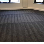 This is a photo of a grey office carpet that has just been professionally steam cleaned.